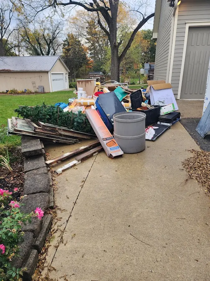 Dumpster being loaded with debris for Estate Cleanout Dumpster Rental in Delanco